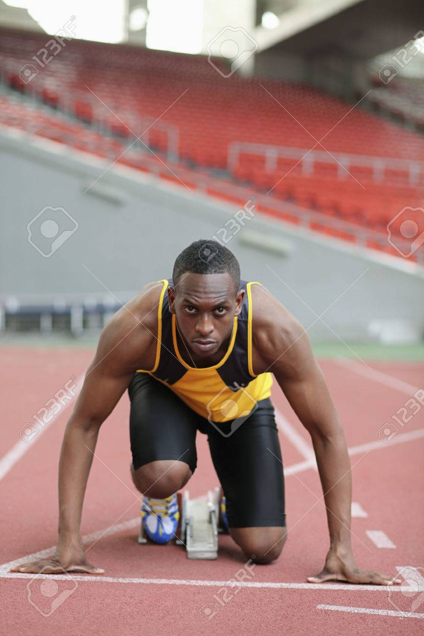 26388743-male-runner-crouching-on-starting-line.jpg