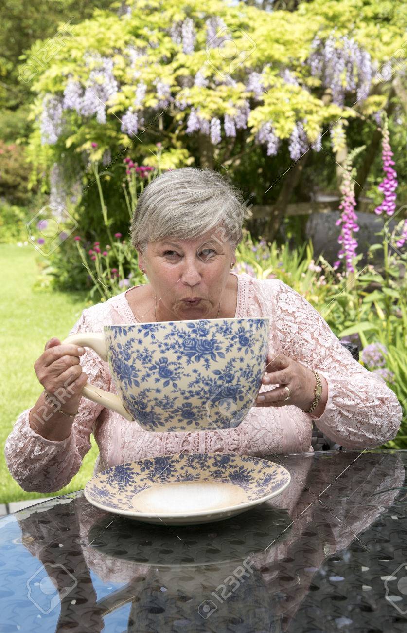 73080123-woman-drinking-tea-from-a-very-large-china-cup-in-a-devonshire-garden.jpg