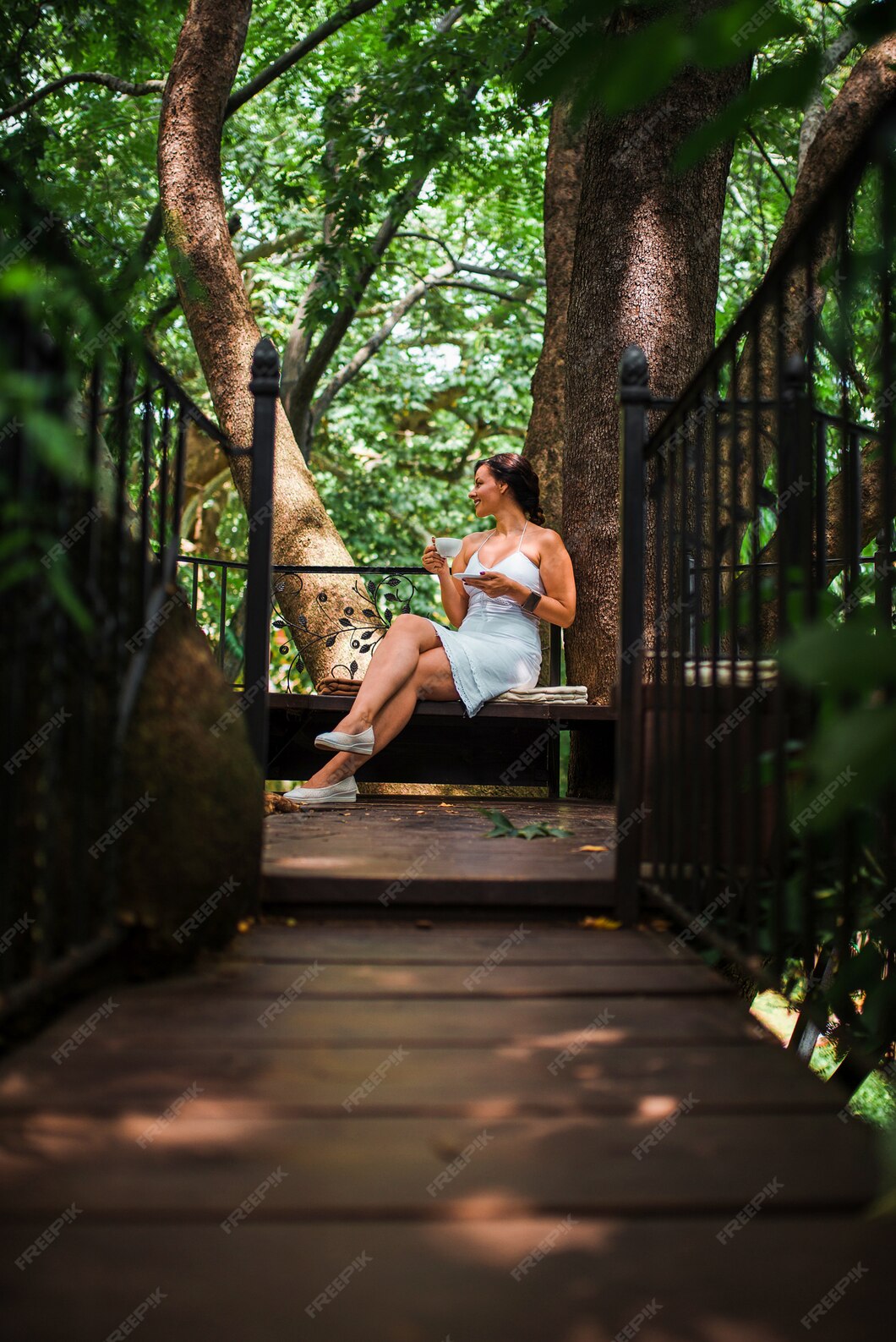 beautiful-woman-drinking-coffee-treehouse-cafe_109710-4654.jpg