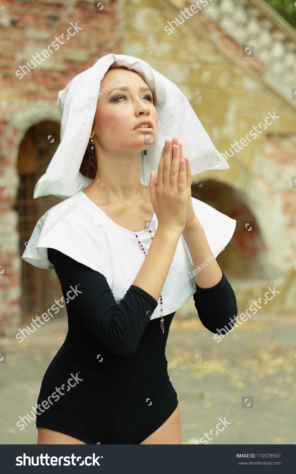 stock-photo-sexy-a-hot-caucasian-girl-wearing-a-nun-outfit-in-sunny-day-outdoor-praying-lookin...jpg